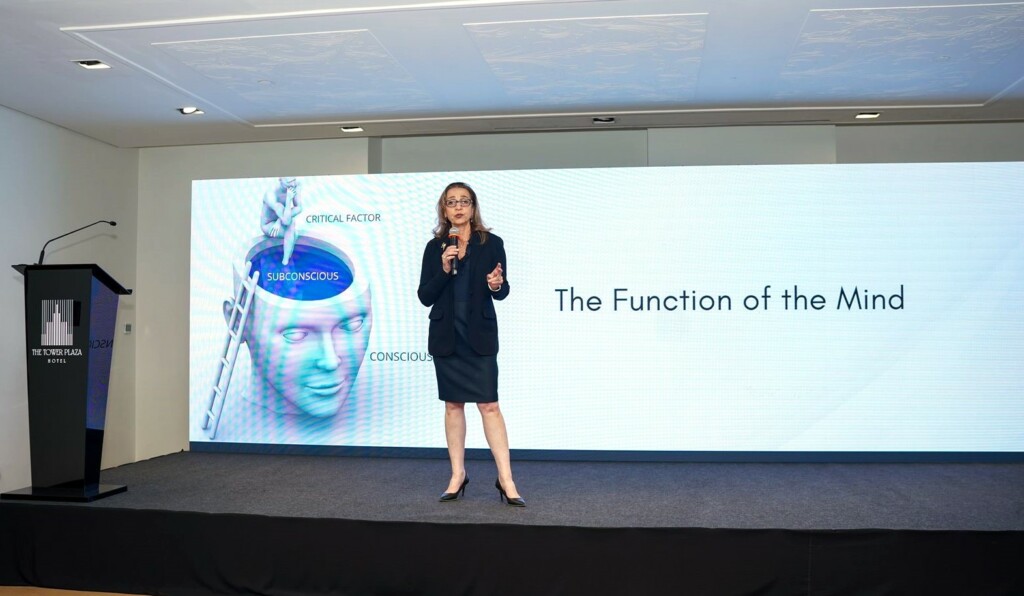 Liza Boubari speaking at a corporate conference in Dubai.